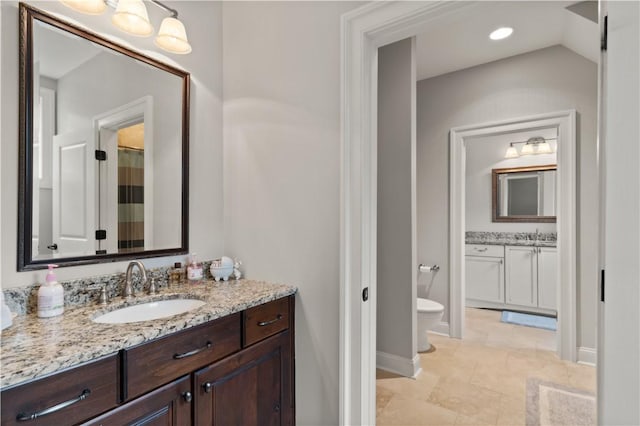 bathroom featuring vanity and toilet