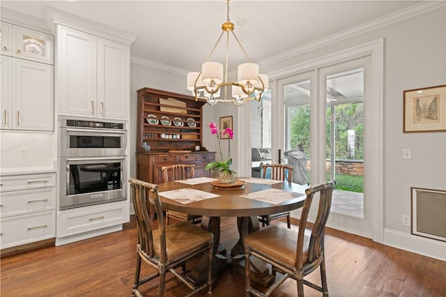 dining area with ornamental molding, dark hardwood / wood-style floors, and a notable chandelier