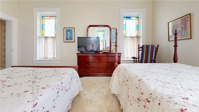 bedroom featuring light carpet