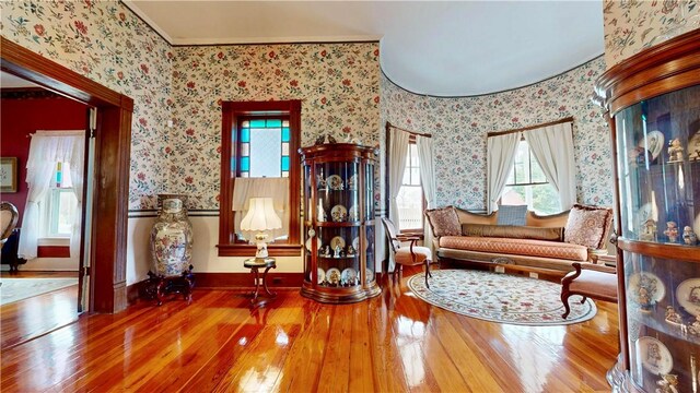 sitting room featuring hardwood / wood-style floors and wallpapered walls