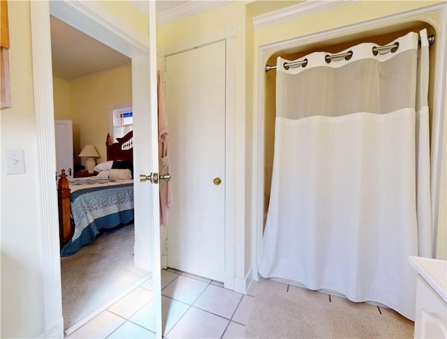 bathroom with tile patterned floors, connected bathroom, and crown molding