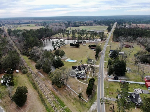 birds eye view of property featuring a rural view and a water view