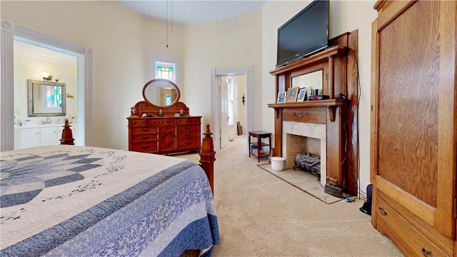 bedroom featuring connected bathroom, a premium fireplace, and carpet