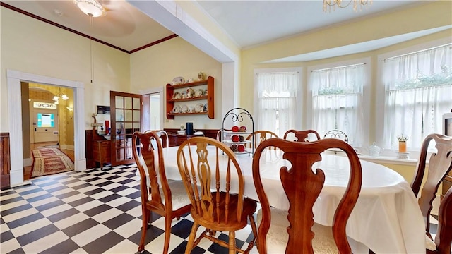 dining space with tile patterned floors, a healthy amount of sunlight, and crown molding