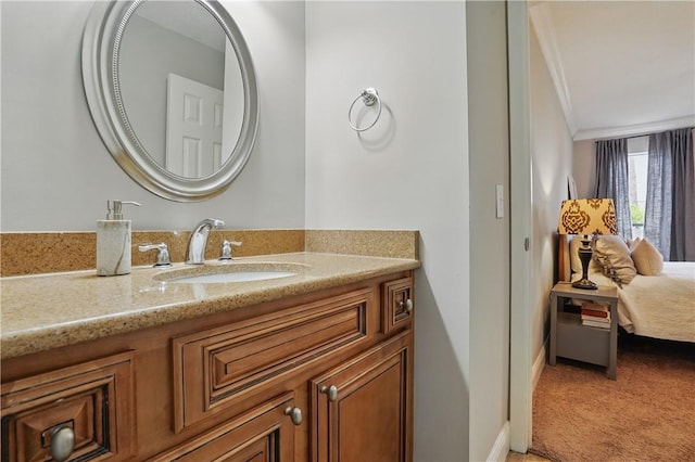 ensuite bathroom featuring ornamental molding and vanity