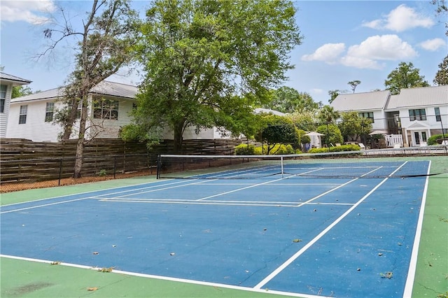 view of tennis court featuring fence and community basketball court