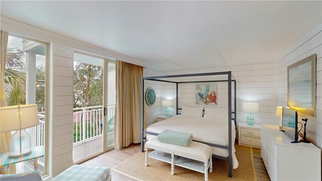 bedroom featuring light wood-type flooring and access to outside