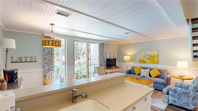 1175 N Beachview Dr Unit 337, Jekyll Island, GA 31527 - kitchen with a sink, crown molding, open floor plan, and visible vents