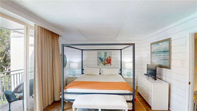 1175 N Beachview Dr Unit 337, Jekyll Island, GA 31527 - bedroom featuring wood walls, wood finished floors, and access to exterior