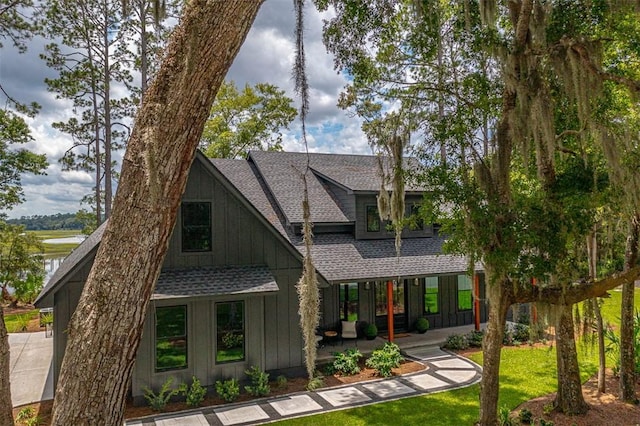 view of front of house with a porch and a front lawn