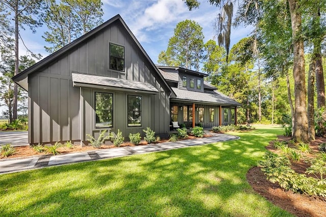 rear view of property with a yard