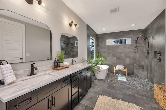 bathroom with tile patterned floors, vanity, and independent shower and bath