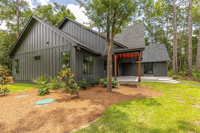 back of house featuring a lawn and a patio