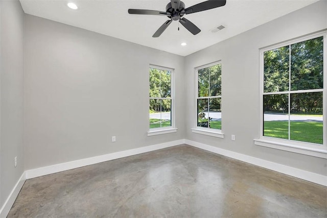 spare room featuring ceiling fan and concrete flooring