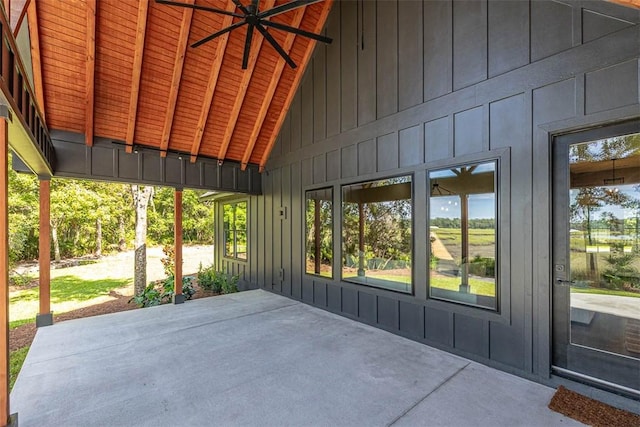 unfurnished sunroom featuring lofted ceiling with beams, ceiling fan, and wood ceiling