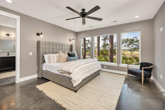 bedroom featuring ensuite bathroom, ceiling fan, sink, and a textured ceiling