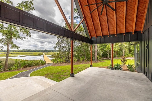 view of patio featuring a water view and ceiling fan