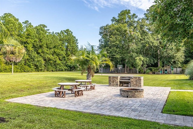 view of home's community featuring a yard, a patio, and a fire pit