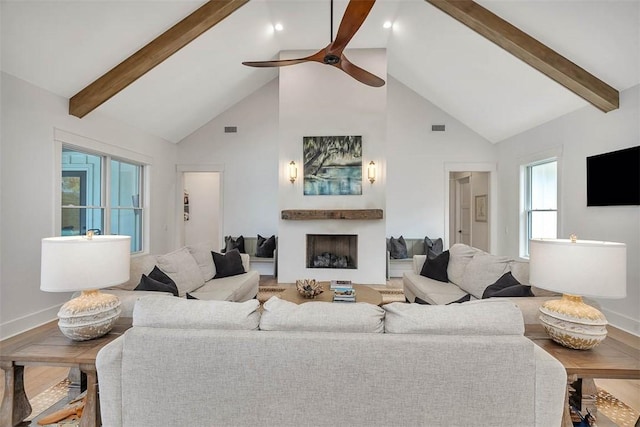 living room featuring hardwood / wood-style floors, high vaulted ceiling, ceiling fan, and beam ceiling