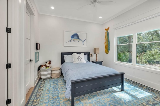 bedroom with ceiling fan, crown molding, and wood-type flooring