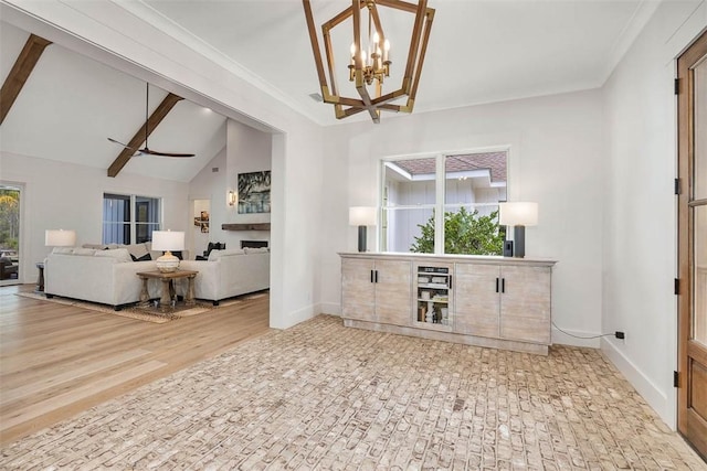 living room with lofted ceiling with beams, ceiling fan with notable chandelier, and wood-type flooring