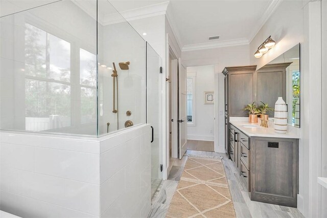 bathroom with hardwood / wood-style floors, vanity, an enclosed shower, and ornamental molding