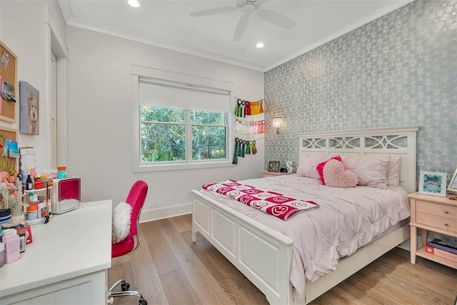 bedroom featuring ceiling fan, light hardwood / wood-style floors, and ornamental molding