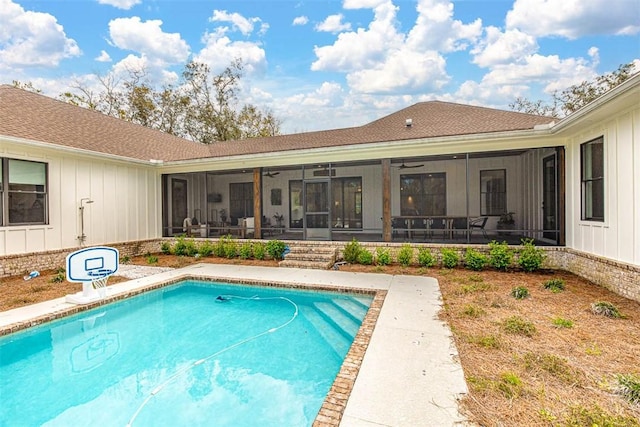 view of swimming pool featuring a sunroom