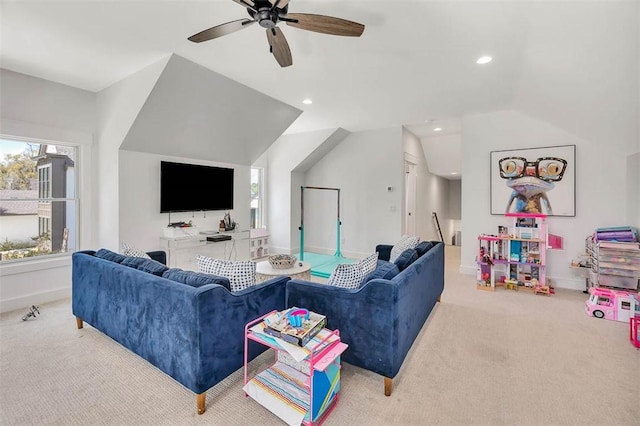 carpeted living room featuring ceiling fan and vaulted ceiling