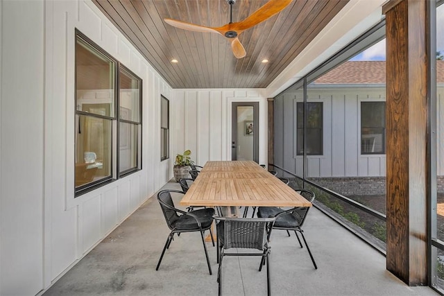 sunroom / solarium with ceiling fan and wooden ceiling