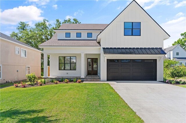 98 Thompson Cv, Saint Simons Island, GA 31522 - modern farmhouse style home with driveway, a front lawn, board and batten siding, a standing seam roof, and a shingled roof