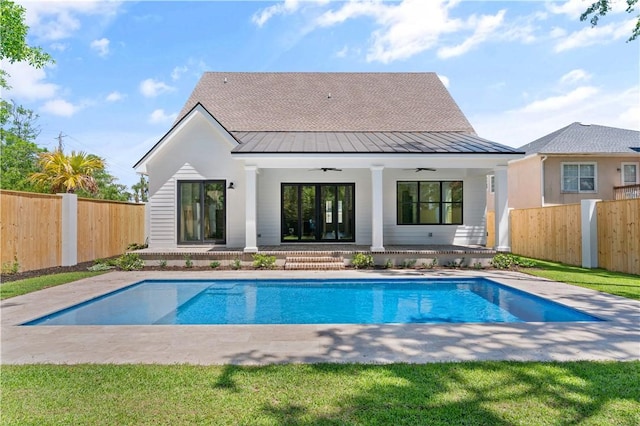 98 Thompson Cv, Saint Simons Island, GA 31522 - back of house with a standing seam roof, a fenced backyard, ceiling fan, and metal roof