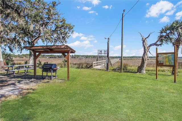 view of yard featuring fence and a rural view