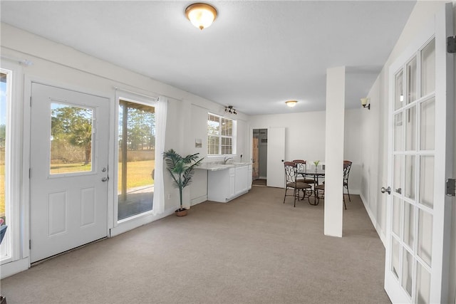 interior space with french doors and light carpet