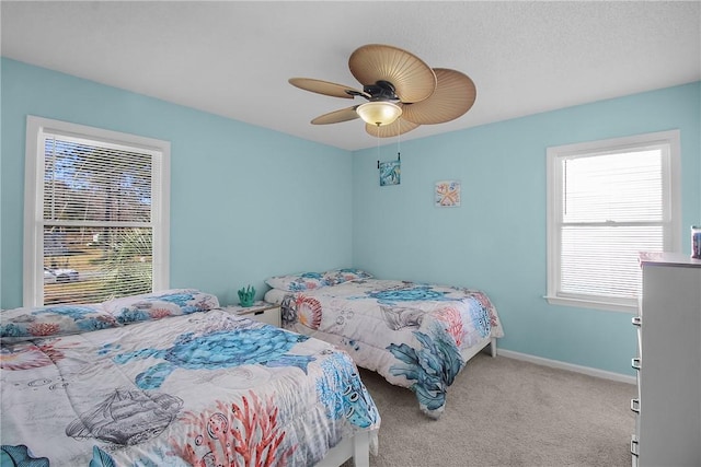 bedroom featuring light carpet, ceiling fan, and baseboards