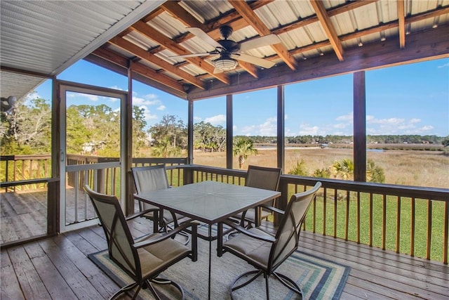 unfurnished sunroom with ceiling fan