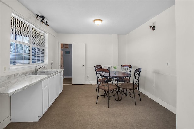 dining space featuring dark colored carpet