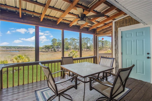 sunroom / solarium with ceiling fan and beamed ceiling