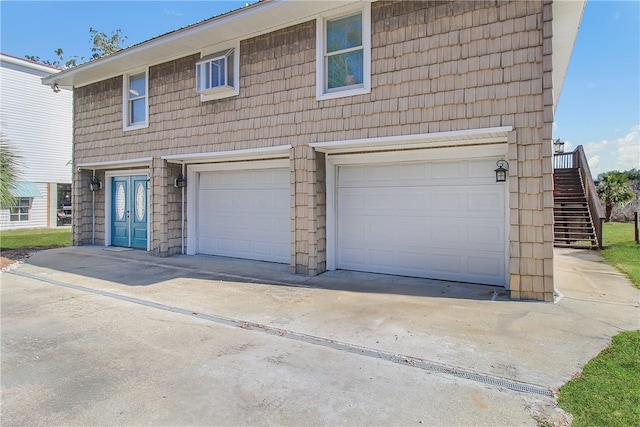 view of front of home with stairs and a garage