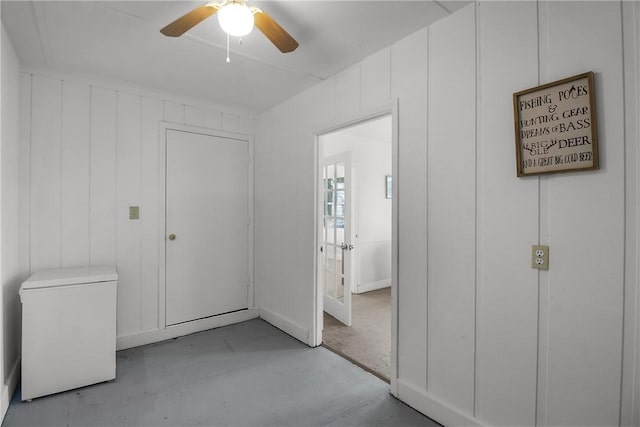 unfurnished bedroom with ceiling fan, concrete floors, and refrigerator