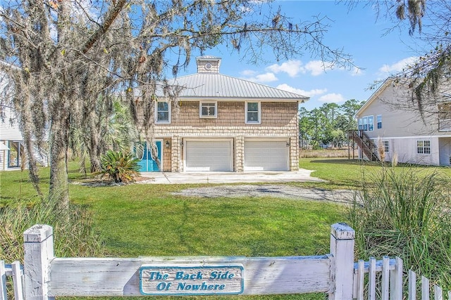 view of front of home featuring driveway, an attached garage, stairs, fence, and a front yard