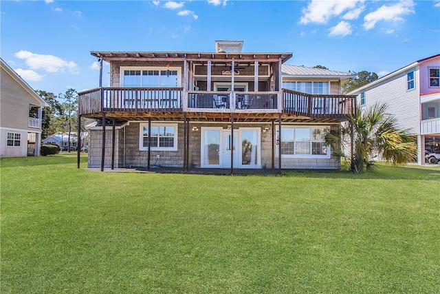 back of property with a lawn and a wooden deck