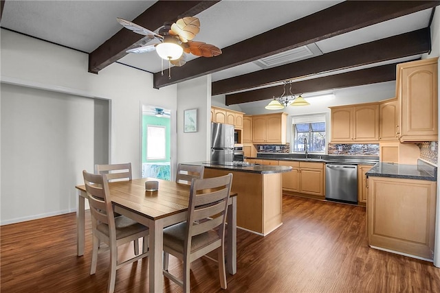 kitchen featuring appliances with stainless steel finishes, dark countertops, and light brown cabinets