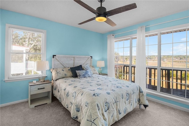 carpeted bedroom featuring baseboards and a ceiling fan