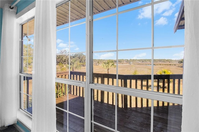 unfurnished sunroom featuring a rural view