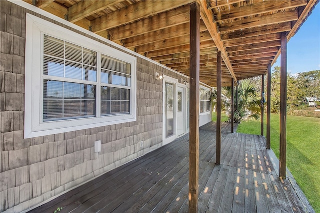 wooden terrace with a lawn