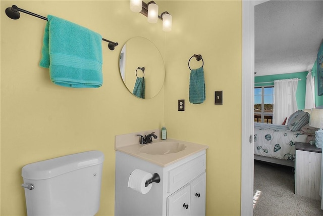 ensuite bathroom featuring toilet, vanity, and ensuite bathroom