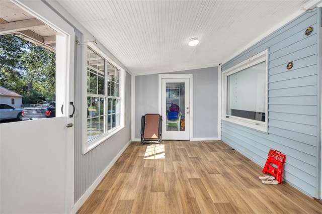 unfurnished sunroom featuring vaulted ceiling