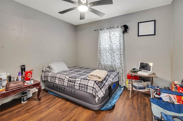 bedroom featuring ceiling fan and dark hardwood / wood-style flooring