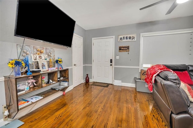 living room with hardwood / wood-style flooring and ceiling fan